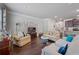 Spacious living area with hardwood floors, comfortable seating, and a view into the dining area at 221 Irwell Path, Lawrenceville, GA 30044