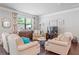 Cozy living room featuring comfortable seating, hardwood floors, and stylish decor at 221 Irwell Path, Lawrenceville, GA 30044