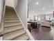 Inviting living room with staircase, hardwood floors, and abundant natural light at 221 Irwell Path, Lawrenceville, GA 30044