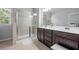 Luxurious bathroom with double vanity, a glass shower, and modern finishes at 221 Irwell Path, Lawrenceville, GA 30044