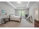 Spacious main bedroom features a tray ceiling, large windows, and ensuite bathroom access at 221 Irwell Path, Lawrenceville, GA 30044