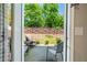 Charming patio area features seating, potted plants, and a view of the fenced backyard at 221 Irwell Path, Lawrenceville, GA 30044