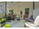 Cozy patio with outdoor seating, potted plants, and brick accents for relaxing or entertaining at 221 Irwell Path, Lawrenceville, GA 30044