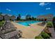 Community pool area with lounge chairs and clear blue water for a refreshing experience at 221 Irwell Path, Lawrenceville, GA 30044