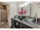 Modern bathroom with double glass bowl sinks, vanity with black granite countertop, and tiled walk-in shower at 4101 Dunwoody Club Dr # 49, Atlanta, GA 30350