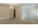 Spacious bedroom featuring a chandelier, plush carpet, and closet providing ample storage space at 4101 Dunwoody Club Dr # 49, Atlanta, GA 30350