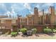 A view of the brick exterior, patio area, and manicured backyard at 4101 Dunwoody Club Dr # 49, Atlanta, GA 30350