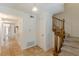 Hallway showcasing tile flooring, a staircase, and a view into other rooms at 4101 Dunwoody Club Dr # 49, Atlanta, GA 30350