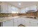Updated kitchen with white cabinets, decorative backsplash, and stainless hood at 4101 Dunwoody Club Dr # 49, Atlanta, GA 30350