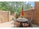 Private brick patio features an umbrella covered dining table with seating for six at 4101 Dunwoody Club Dr # 49, Atlanta, GA 30350