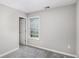 Cozy bedroom with neutral walls and carpet flooring; bright window provides natural light at 9188 Jefferson Village Sw Dr, Covington, GA 30014