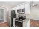 Updated kitchen with granite countertops, stainless steel appliances, and modern cabinetry at 9188 Jefferson Village Sw Dr, Covington, GA 30014