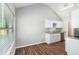 Bright kitchen area featuring modern cabinetry, granite countertops, and hardwood flooring at 9188 Jefferson Village Sw Dr, Covington, GA 30014