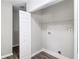 Functional laundry area with washer/dryer hookups and storage shelving at 9188 Jefferson Village Sw Dr, Covington, GA 30014