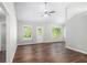 Spacious living room filled with natural light, wood floors, and modern ceiling fan at 9188 Jefferson Village Sw Dr, Covington, GA 30014