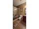 Bathroom with a glass enclosed shower and vanity with dark wood cabinets at 1231 Creek Forest Ln, Austell, GA 30106