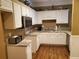 Bright kitchen with white cabinetry, stainless steel appliances, and hardwood flooring at 1231 Creek Forest Ln, Austell, GA 30106