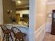Eat-in kitchen with granite countertops, a breakfast bar, and white cabinets at 1231 Creek Forest Ln, Austell, GA 30106