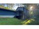 Backyard view of home with a screened-in porch, lush greenery, and mature trees offering shade at 145 Huntcliff Ct, Fayetteville, GA 30214