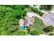Aerial view of the home and backyard with a gorgeous pool surrounded by lush greenery at 255 Ashmere Ct, Tyrone, GA 30290