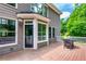 The outdoor back deck features wood floors, white railings, and a patio table set at 255 Ashmere Ct, Tyrone, GA 30290