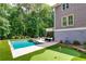 Beautiful backyard with an in-ground pool, putting green, and lots of greenery at 255 Ashmere Ct, Tyrone, GA 30290