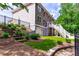 Multi-level backyard featuring patio, deck, landscaped steps, and lush green lawn for outdoor enjoyment at 255 Ashmere Ct, Tyrone, GA 30290