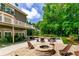 Beautiful backyard with a fire pit, outdoor kitchen, pool, lots of seating, and lush greenery at 255 Ashmere Ct, Tyrone, GA 30290