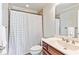 Neat bathroom with a tiled shower/tub featuring a white shower curtain at 255 Ashmere Ct, Tyrone, GA 30290