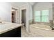 Bright bathroom showcasing a soaking tub and and vanity at 255 Ashmere Ct, Tyrone, GA 30290