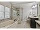 Bright bathroom features a soaking tub, walk-in shower, and double vanity with marble countertops at 255 Ashmere Ct, Tyrone, GA 30290