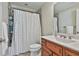 Bathroom with a shower with curtain, a white sink, and wooden vanity at 255 Ashmere Ct, Tyrone, GA 30290