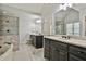 Well-lit bathroom with a soaking tub, walk-in shower, and double vanity with black cabinetry at 255 Ashmere Ct, Tyrone, GA 30290