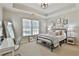 Comfortable bedroom with carpet and a tray ceiling, desk, and a window with bright, natural light at 255 Ashmere Ct, Tyrone, GA 30290