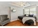 Cozy bedroom features tray ceilings, ceiling fan, and a window that provides ample natural light at 255 Ashmere Ct, Tyrone, GA 30290
