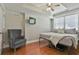 Cozy bedroom with ceiling fan, natural lighting, and hardwood floors for ultimate comfort at 255 Ashmere Ct, Tyrone, GA 30290