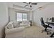 Relaxing bedroom area with white sofa and mini fridge for convenience at 255 Ashmere Ct, Tyrone, GA 30290