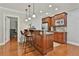 This home has a convenient breakfast bar with wooden cabinetry and granite countertops at 255 Ashmere Ct, Tyrone, GA 30290