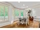 Bright breakfast nook features large windows, hardwood floors, and adjoins a living room with a fireplace at 255 Ashmere Ct, Tyrone, GA 30290