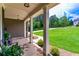 Relaxing front porch with stone pillars, ample seating, and lush greenery offering a peaceful retreat at 255 Ashmere Ct, Tyrone, GA 30290