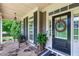 Charming front porch features stone flooring, comfortable seating, and a stylish wreath at 255 Ashmere Ct, Tyrone, GA 30290