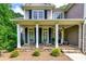 Inviting front porch with stone accents, stylish seating, and a welcoming entrance creating curb appeal at 255 Ashmere Ct, Tyrone, GA 30290