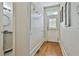 Welcoming hallway with hardwood floors and access to bathroom and exit at 255 Ashmere Ct, Tyrone, GA 30290