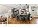 Open-concept kitchen with stainless appliances, eat in bar, and view to the living area at 255 Ashmere Ct, Tyrone, GA 30290