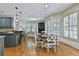 Open-concept kitchen and breakfast area with wood floors, shutters, and views of the living area at 255 Ashmere Ct, Tyrone, GA 30290