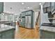 Open kitchen featuring granite countertops, stainless steel appliances, and blue-gray cabinetry at 255 Ashmere Ct, Tyrone, GA 30290