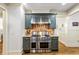 Updated kitchen features stainless steel appliances, custom cabinetry, and a modern vent hood at 255 Ashmere Ct, Tyrone, GA 30290