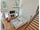 Bright living room with hardwood floors, gas fireplace and comfortable sofa with view of stairs at 255 Ashmere Ct, Tyrone, GA 30290