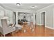 Large living area showcasing hardwood floors, light-filled windows, and elegant column features at 255 Ashmere Ct, Tyrone, GA 30290