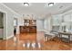 Open-concept living area with hardwood floors, breakfast bar, and bright, natural light throughout at 255 Ashmere Ct, Tyrone, GA 30290